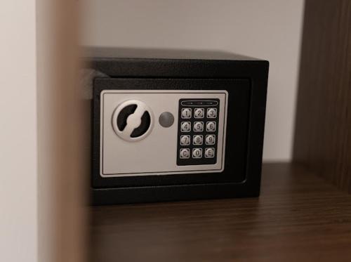 a close up of a safe on a wooden floor at Hôtel Lou Juan in Juan-les-Pins