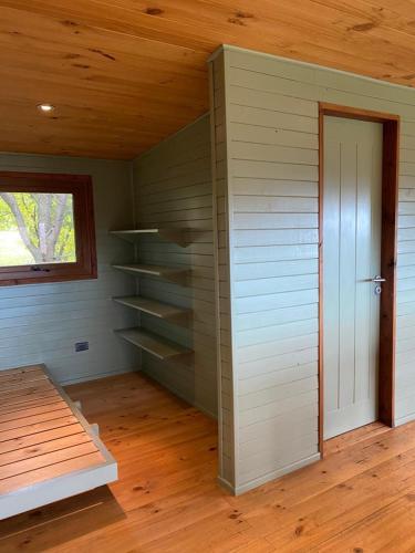 a room with a closet with a window and a door at Lofts Magnolias in Puerto Varas
