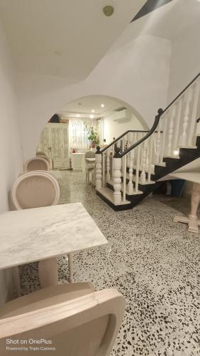 a bathroom with a staircase and toilets in a room at Sea Esta Guest House in Mellieħa