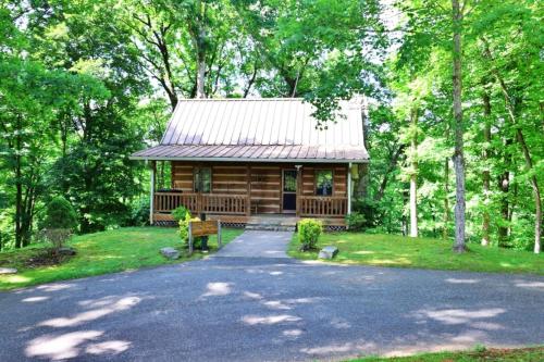 a log cabin in the woods with a driveway at The Ridge in Whittier