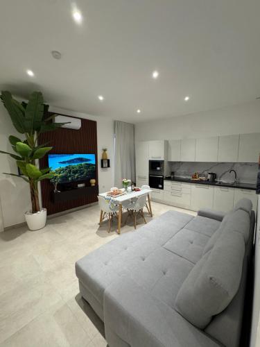 a living room with a large couch and a table at The White Balcony in Il-Gżira