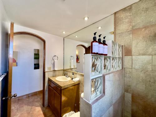 a bathroom with a sink and a mirror at Rosarito Puerto Nuevo Surf 1BR casita and pool in Raulis