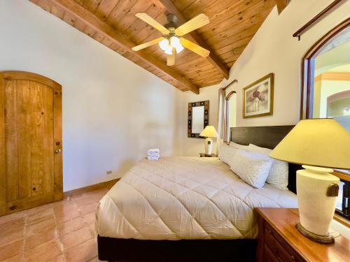 a bedroom with a bed and a ceiling fan at Rosarito Puerto Nuevo Surf 1BR casita and pool in Raulis
