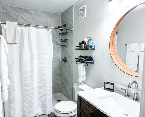 a bathroom with a toilet and a sink and a mirror at Beechview Condo in Beech Mountain
