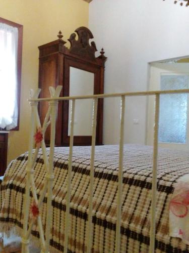 a bedroom with a bed with a wooden head board at Antico Casale dei Sogni agriturismo in Lugo