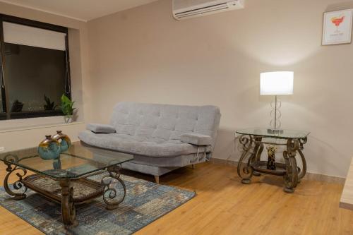a living room with a couch and a table at Apartaestudios - Torre de Cali in Cali