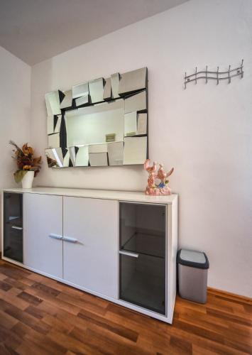 a mirror on a wall above a dresser in a room at Apartments Villa Excellente Belvedere in Pula