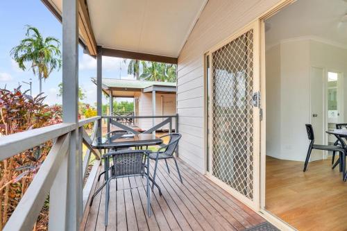 a balcony with a table and chairs on a deck at Darwin FreeSpirit Resort in Darwin