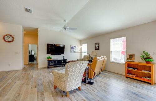 a living room with a table and chairs and a tv at Pet-Friendly Home with Patio in The Villages in Wildwood
