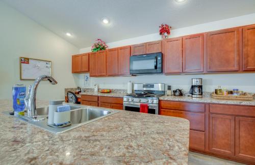 a kitchen with wooden cabinets and a counter top at Pet-Friendly Home with Patio in The Villages in Wildwood