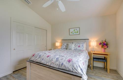 a bedroom with a bed and a night stand with a table at Pet-Friendly Home with Patio in The Villages in Wildwood