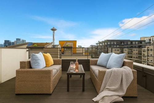 two wicker chairs and a table on a balcony at Near Space Needle Climate Pledge Roof Deck in Seattle