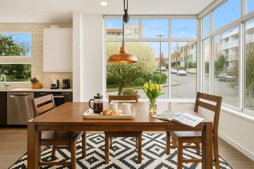 a kitchen with a wooden table with a plate of food at Near Space Needle Climate Pledge Roof Deck in Seattle
