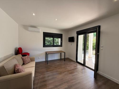 a living room with a couch and a table at Montelimar Location in Montélimar