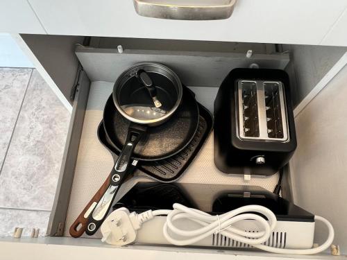 a box with utensils and other kitchen utensils at Self-contained ground level cottage with hill view in Edinburgh
