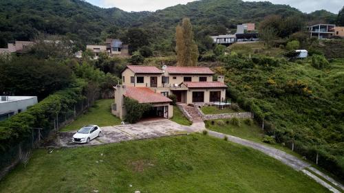 an aerial view of a house with a car parked in the yard at Casa de Campo Urqukunapi Wasi in San Salvador de Jujuy