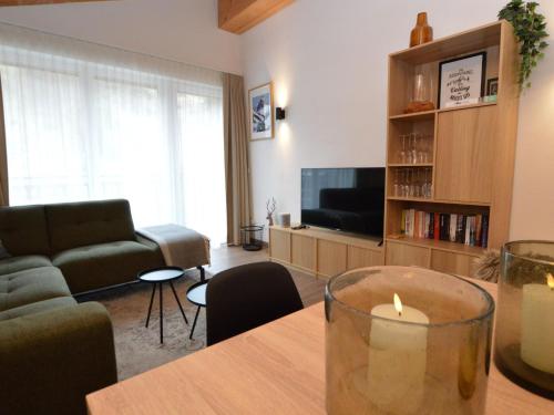 a living room with a candle on a table at Emma Top 4 in Dienten am Hochkönig