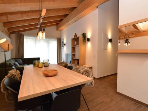 a living room with a wooden table and a couch at Emma Top 4 in Dienten am Hochkönig