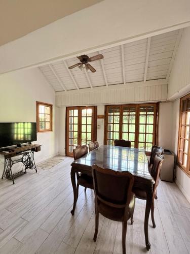 una sala da pranzo con tavolo e ventilatore a soffitto di Casa 9 de julio a Tandil