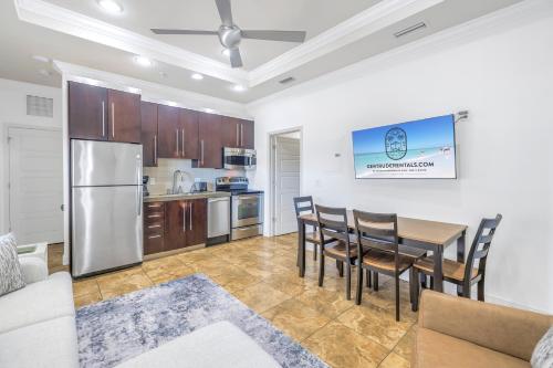 a kitchen and dining room with a table and chairs at New Listing! Pool Jacuzzi, 3-min to Beach Bars & Entertainment! in Siesta Key