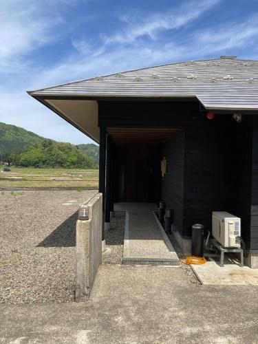a black building with a building with a appliance in it at 勝山四季の宿 清流亭 一棟貸で周囲500メートルに民家なし in Katsuyama