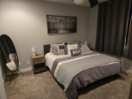 a bedroom with a bed and a dresser and a mirror at Welcome to Luigi! in Omaha