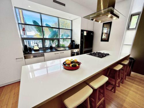 a kitchen with a bowl of fruit on a counter at Luxury 2-Bedroom Townhouse in Adelaide CBD in Adelaide