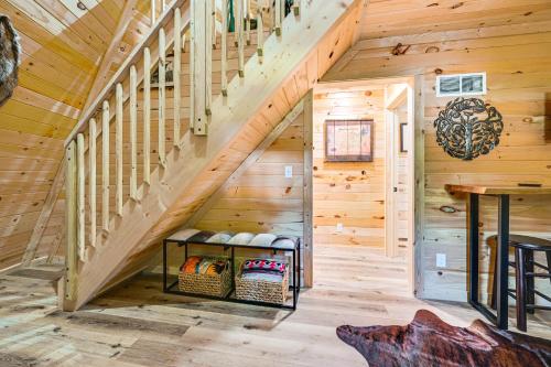 a staircase in a log cabin with a wooden stair case at 5 Mi to Mammoth Cave NP Teepee Studio Escape in Cub Run
