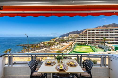 a table and chairs on a balcony with a view of the ocean at Sol del Sur Ocean View in Puerto de Santiago