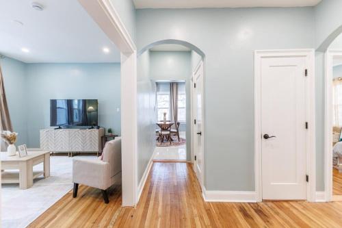 a hallway with a living room with blue walls at Stylish 3 Bedroom Apartment in Boston