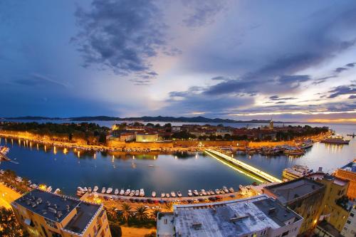 a view of a city with a harbor at night at Tequila Bar Hostel in Zadar
