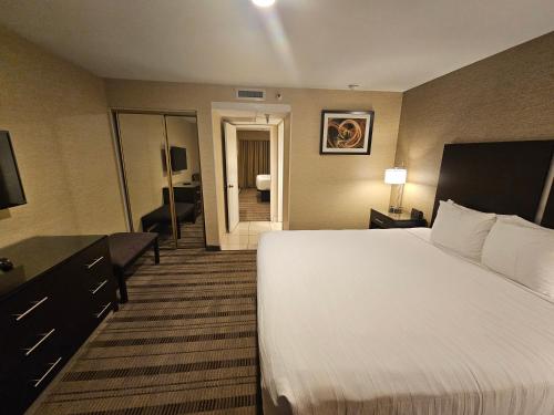 a hotel room with a bed and a living room at Best Western Pasadena Royale Inn & Suites in Pasadena