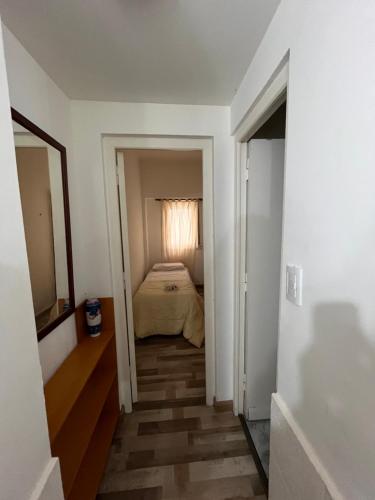 a hallway leading to a bedroom with a bed at Rincón del mar in Mar del Plata