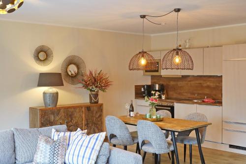 a kitchen and living room with a table and chairs at Ambiente-Annabelle in Göhren-Lebbin