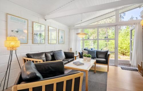 a living room with a couch and a table at Cassiopeja in Strandby Gårde
