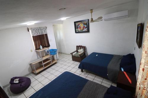 a bedroom with a bed and a tiled floor at Casa Tortuga - Excellent Location - Close to Beach in Lázaro Cárdenas