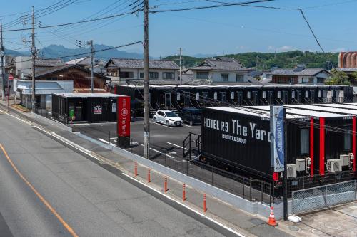an empty street with a car driving down a road at HOTEL R9 The Yard Tomiokananokaichi in Tomioka