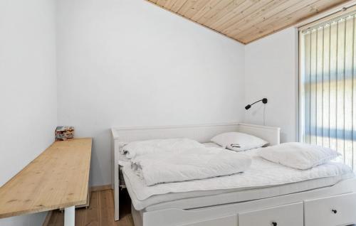 a white bedroom with a bed and a desk at 3 Bedroom Lovely Home In Rødby in Rødby