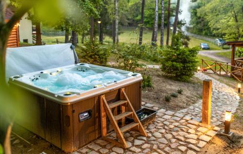 a hot tub with a ladder in a backyard at 2 Bedroom Nice Home In Bobolice in Bobolice