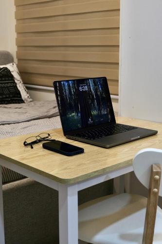 a laptop computer sitting on top of a desk at Tiny's BnB in Davao City