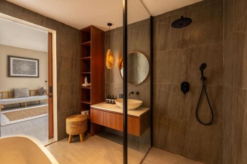 a bathroom with a sink and a shower at Solencia Villa by Betterplace in Jimbaran