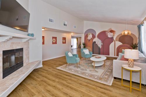 a living room with a couch and a fireplace at Desert Dream Oasis - Spa, Cabana, Firepit, Disney and Hulu in Yucca Valley