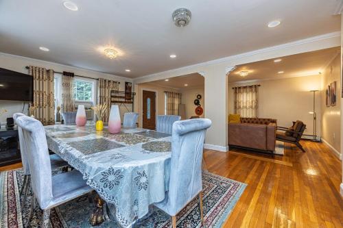 a dining room with a table and blue chairs at Extremely Spacious Home 10 Mins to The Encore in Medford