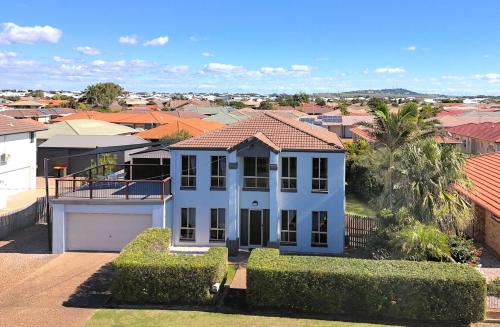 a white house in a city with houses at 114 Woongarra Scenic Drive in Bargara