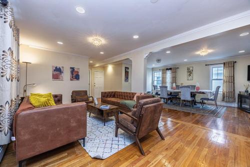 a living room with couches and a dining room at Extremely Spacious Home 10 Mins to The Encore in Medford