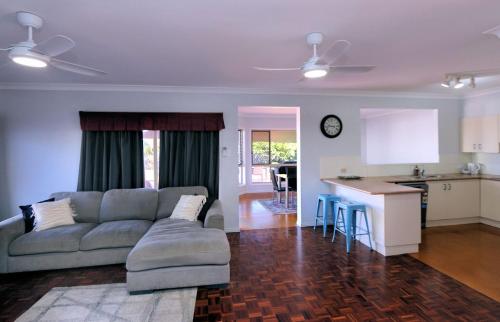 a living room with a couch and a kitchen at 114 Woongarra Scenic Drive in Bargara