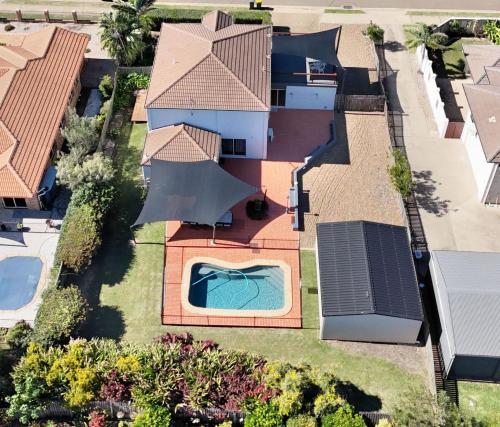 an overhead view of a house with a swimming pool at 114 Woongarra Scenic Drive in Bargara
