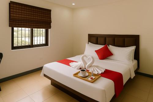 a hotel room with a bed with a tray of food at Queen room only near sm mall Fast Wifi in Malabañas