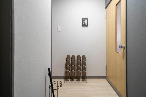 a hallway with a row of brown chairs next to a door at Silk Court 405 in Chitose
