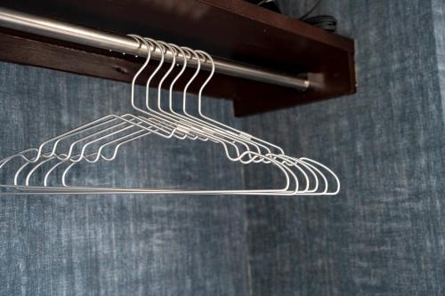 a metal rack with a wire skeleton on a wall at Silk Court 405 in Chitose